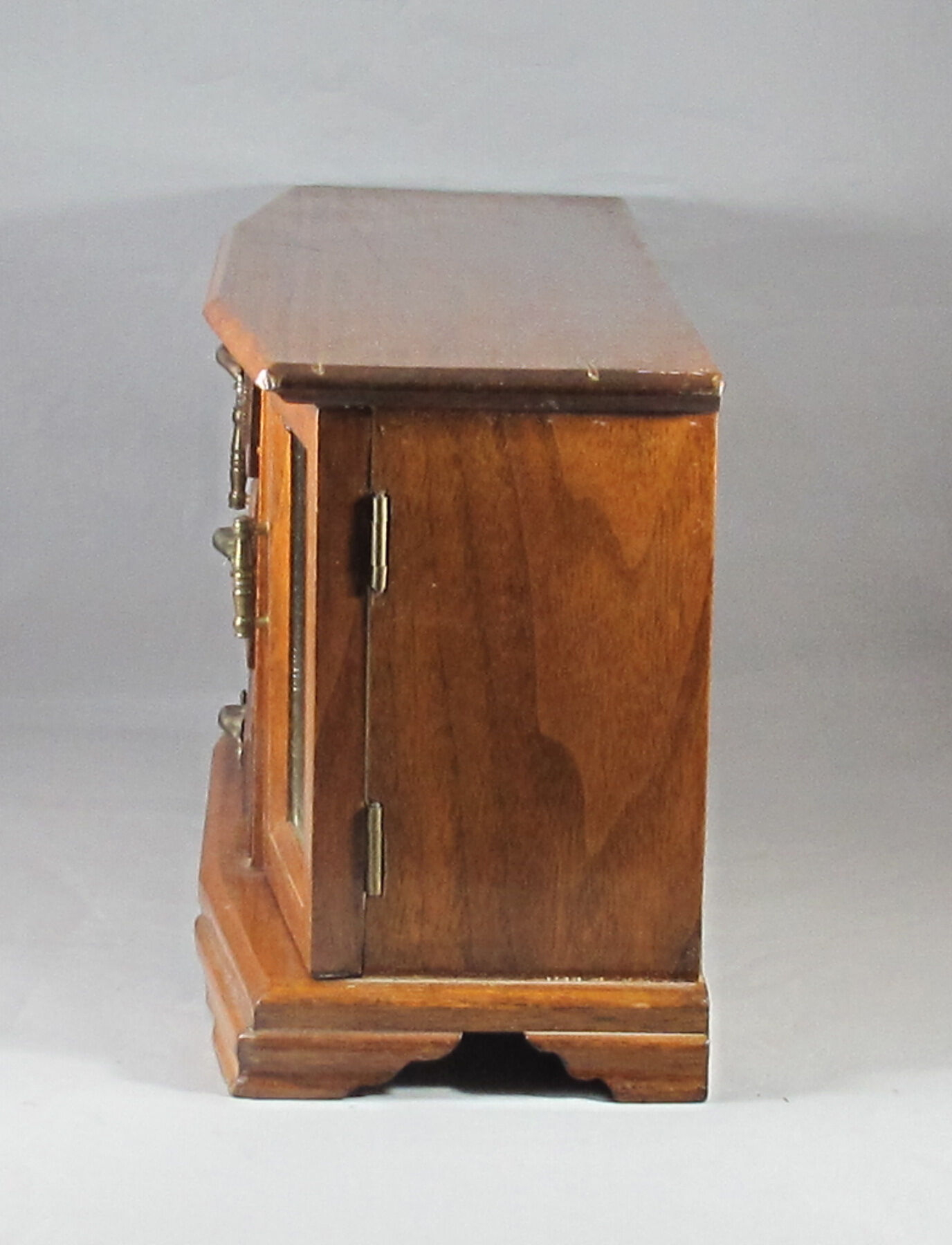 Wooden jewelry box in the shape of a chest of drawers