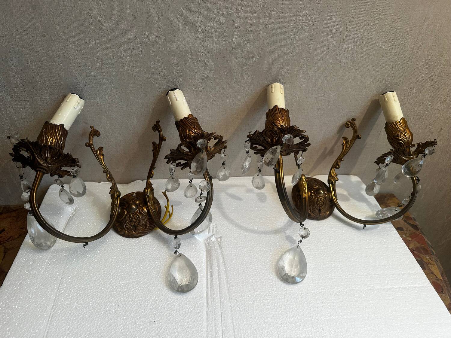 Pair of Louis XV style wall sconces in gilded bronze with glass pendants.