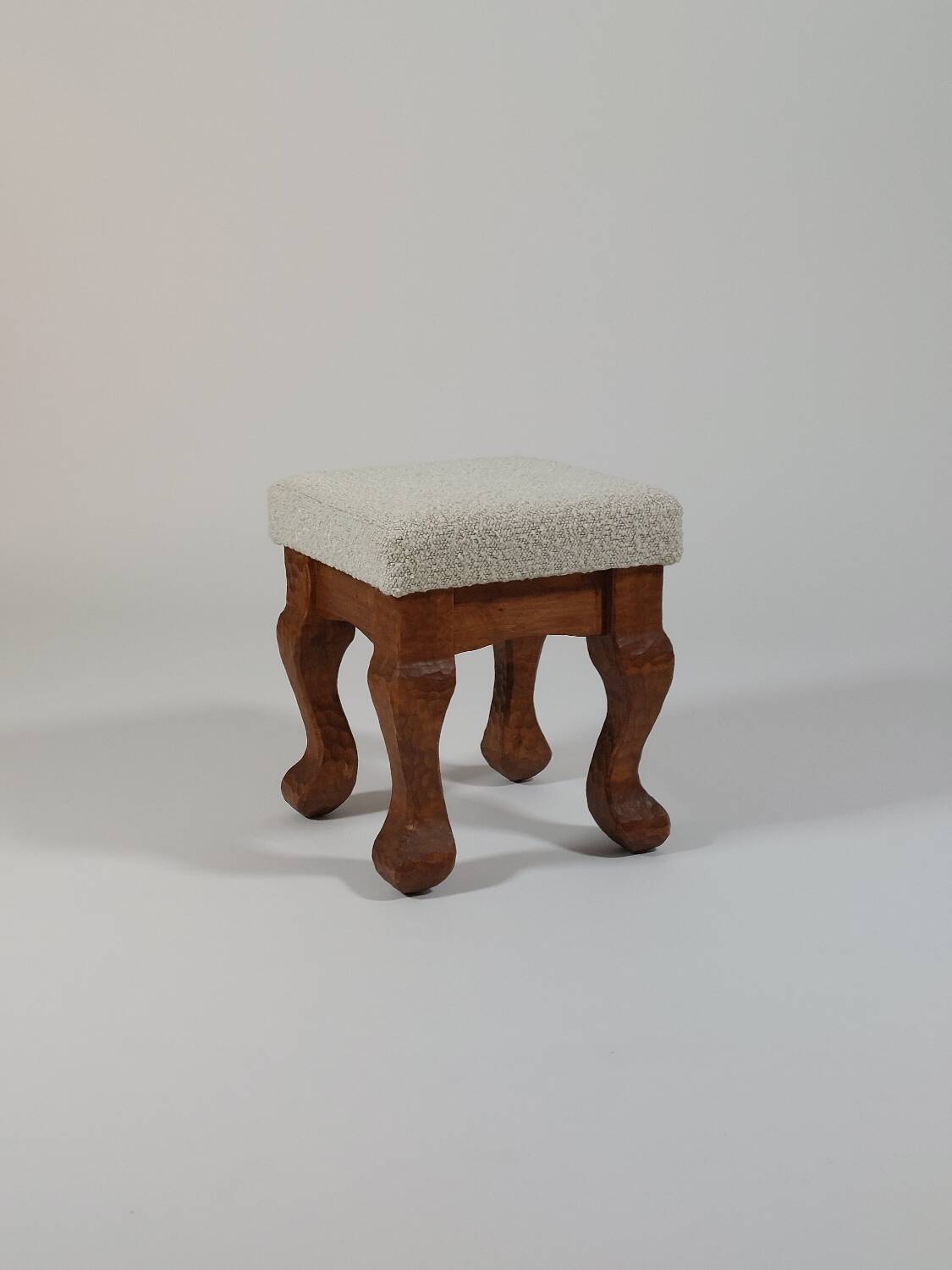 Unique sculpted stools, freshly upholstered and exquisite.