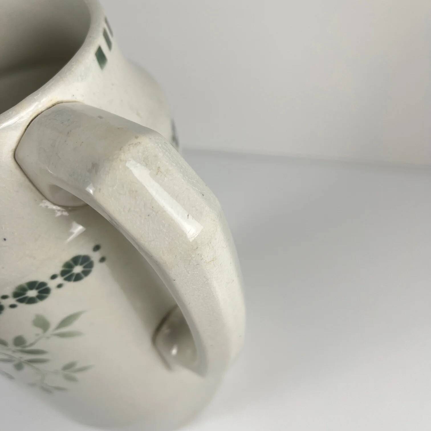 Antique earthenware pitcher, green floral decoration, fine ironstone from the late 19th to early 20th century.