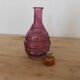 Vintage pink pressed glass carafe – retro decorative bottle with wooden stopper.