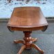 Round dining table, solid wood, central leg, extendable flaps, 20th century.