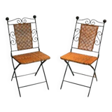 Paire de chaises pliables en fer forgé et rotin.