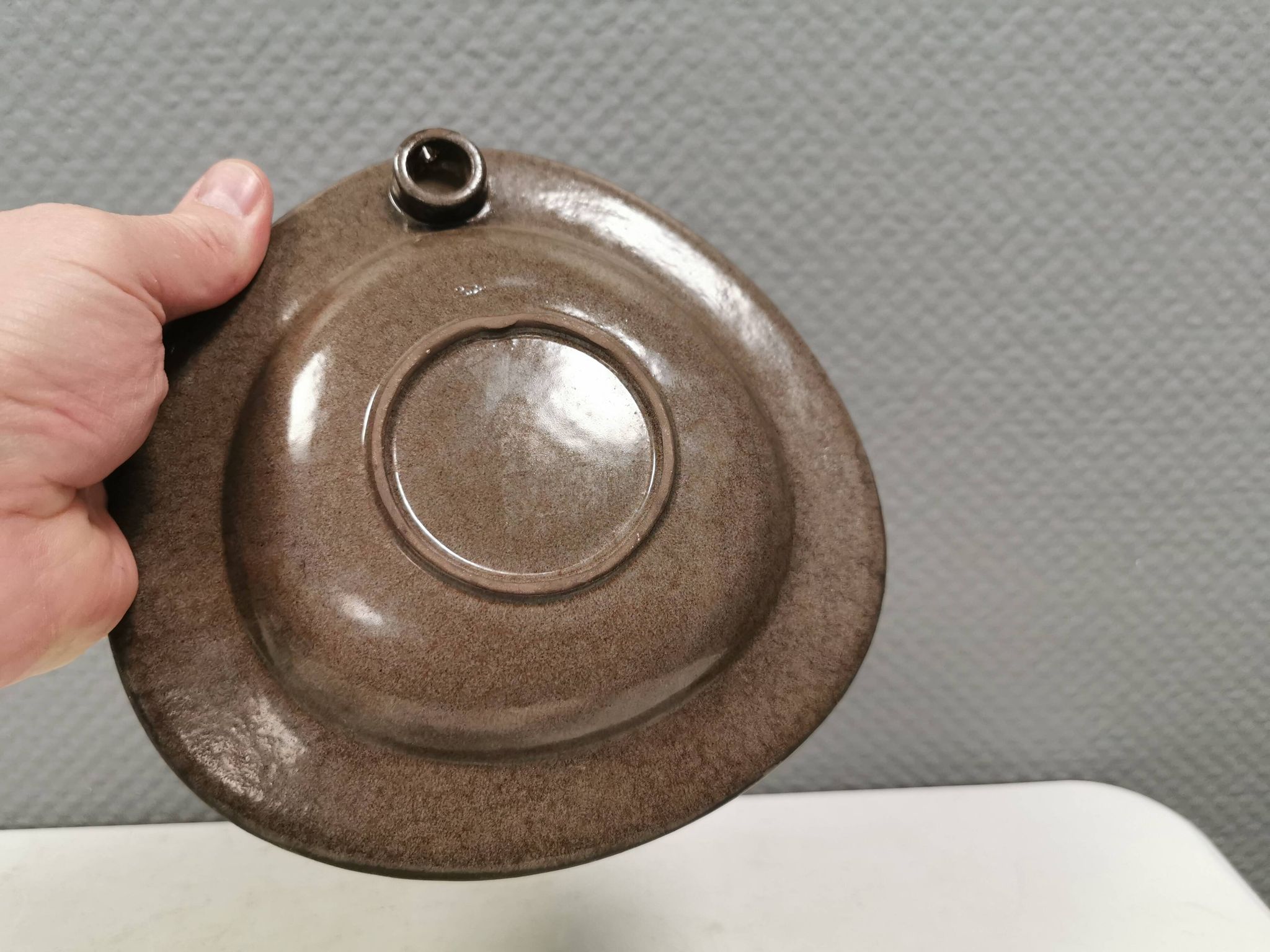 Wall-mounted candlestick in grayish colors, Danish and from the 1970s-80s.