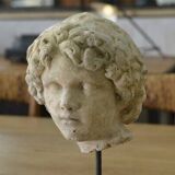 Sculpture of a head in reconstituted stone carved in the antique style of the 19th century