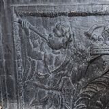 huge old fireplace plate has decoration of angels, crown and fleurs-de-lis