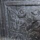 huge old fireplace plate has decoration of angels, crown and fleurs-de-lis