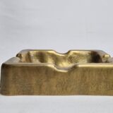 Empty pocket brutalist-inspired ashtray in gilded bronze