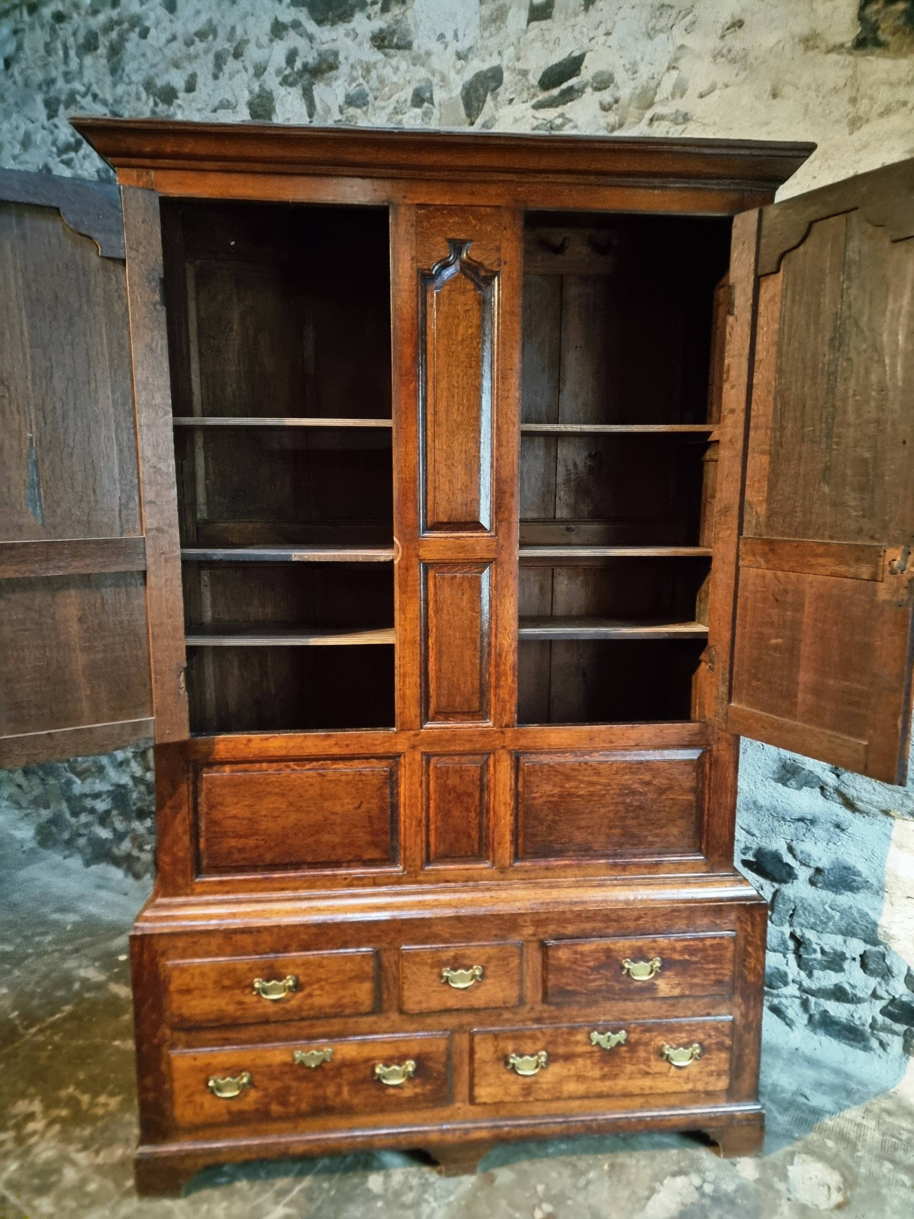 Antique English oak wardrobe with drawers, England, circa 1800–1820.