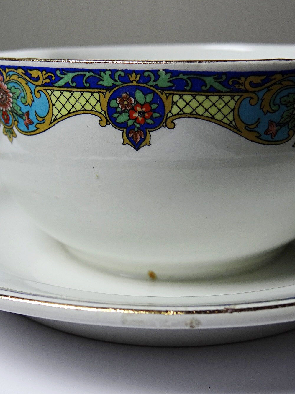 Old Lunéville sauce boat, opaque porcelain with polychrome decoration.