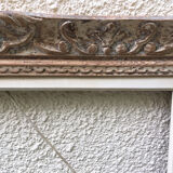 Carved wood frame.