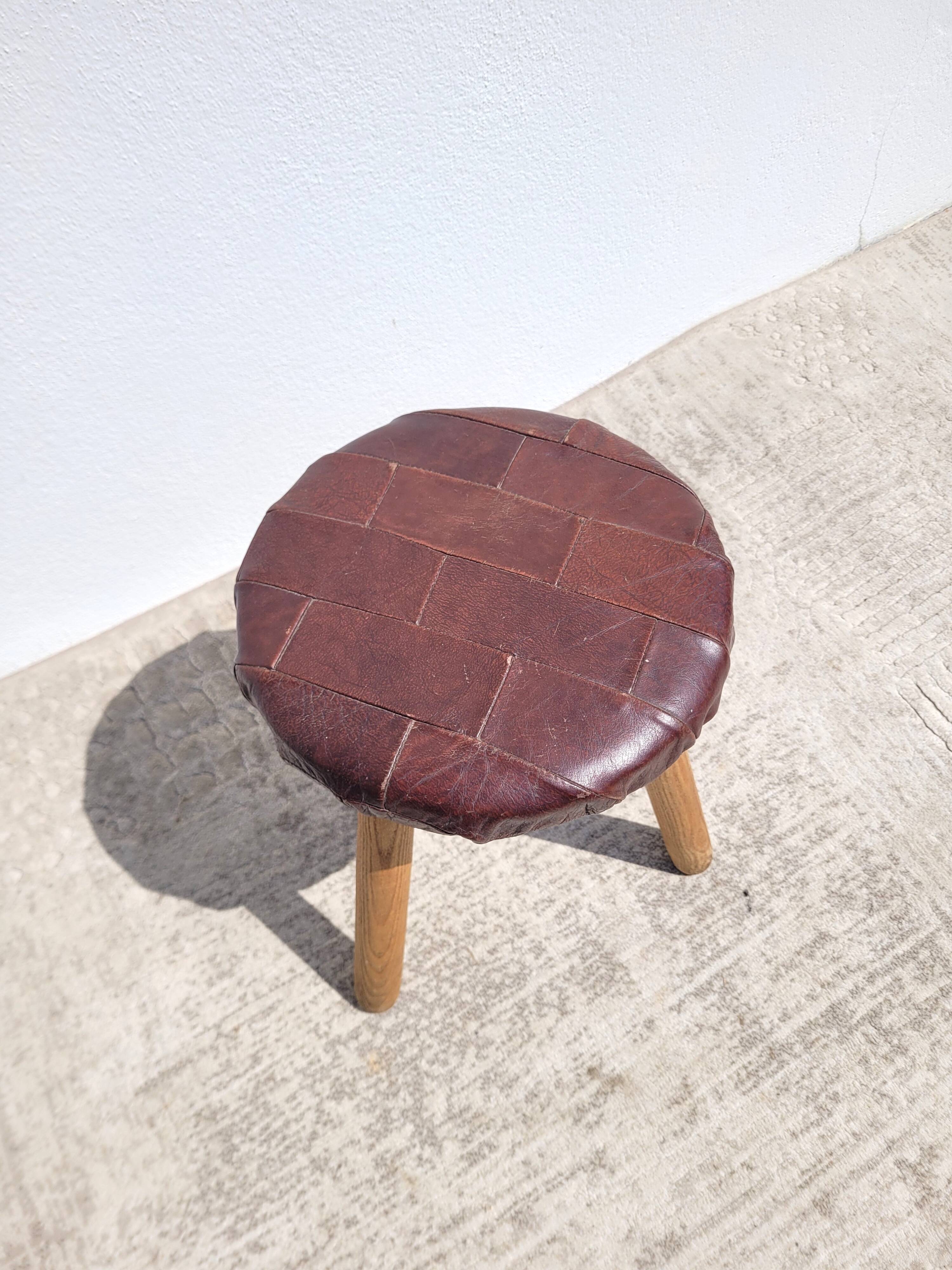 Leather-upholstered tripod stool