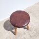 Leather-upholstered tripod stool
