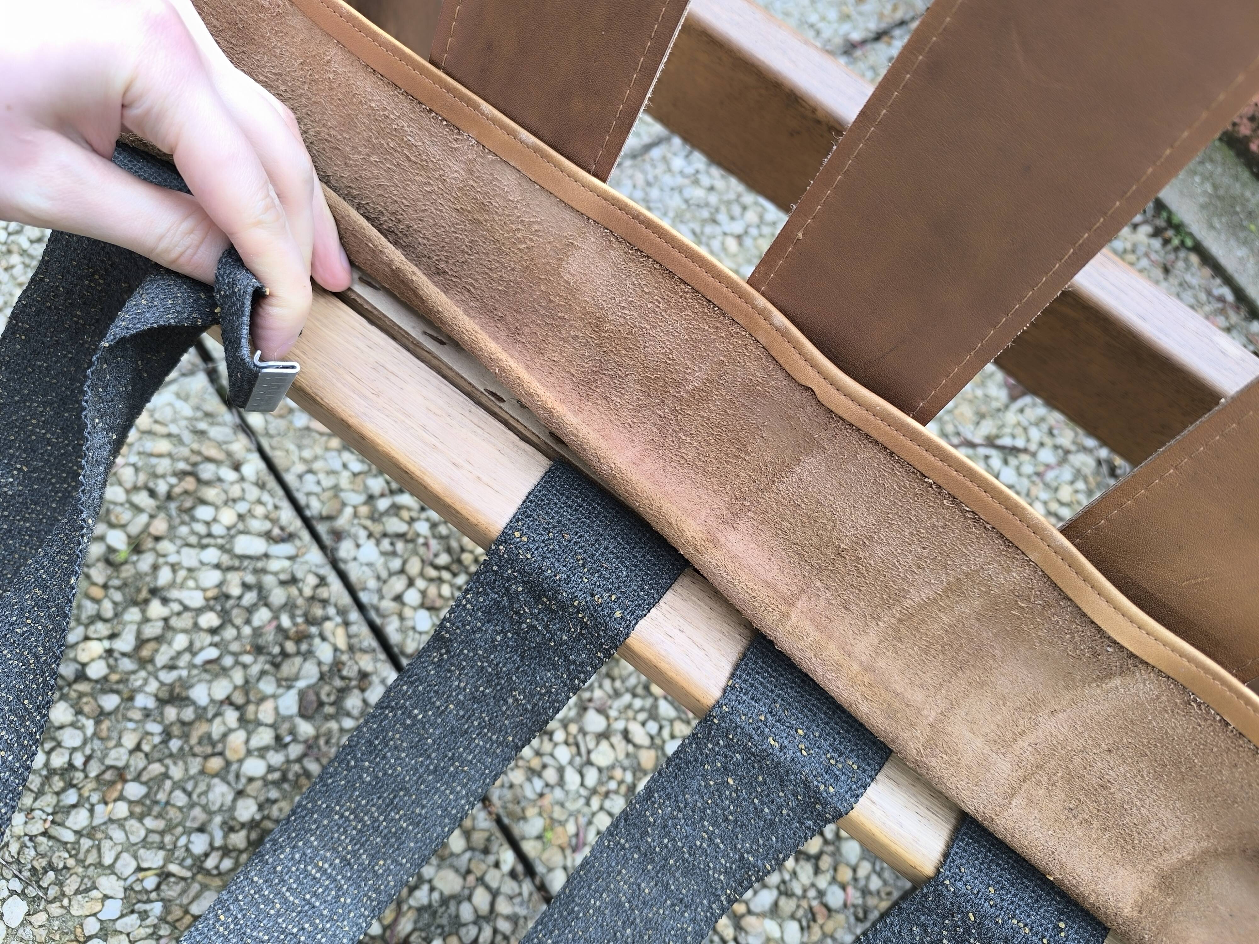 Pair of solid wood and leather lounge chairs, European work, circa 1970.