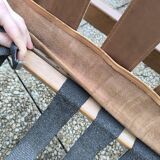 Pair of solid wood and leather lounge chairs, European work, circa 1970.