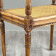 Banquette / tabouret en bois sculpté et cannage, XXe siècle