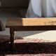 Brown Indonesian teak coffee table, with a border and cylindrical legs H40 L103.