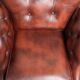 Cowhide chesterfield armchair in a warm brown colour with decorative nails