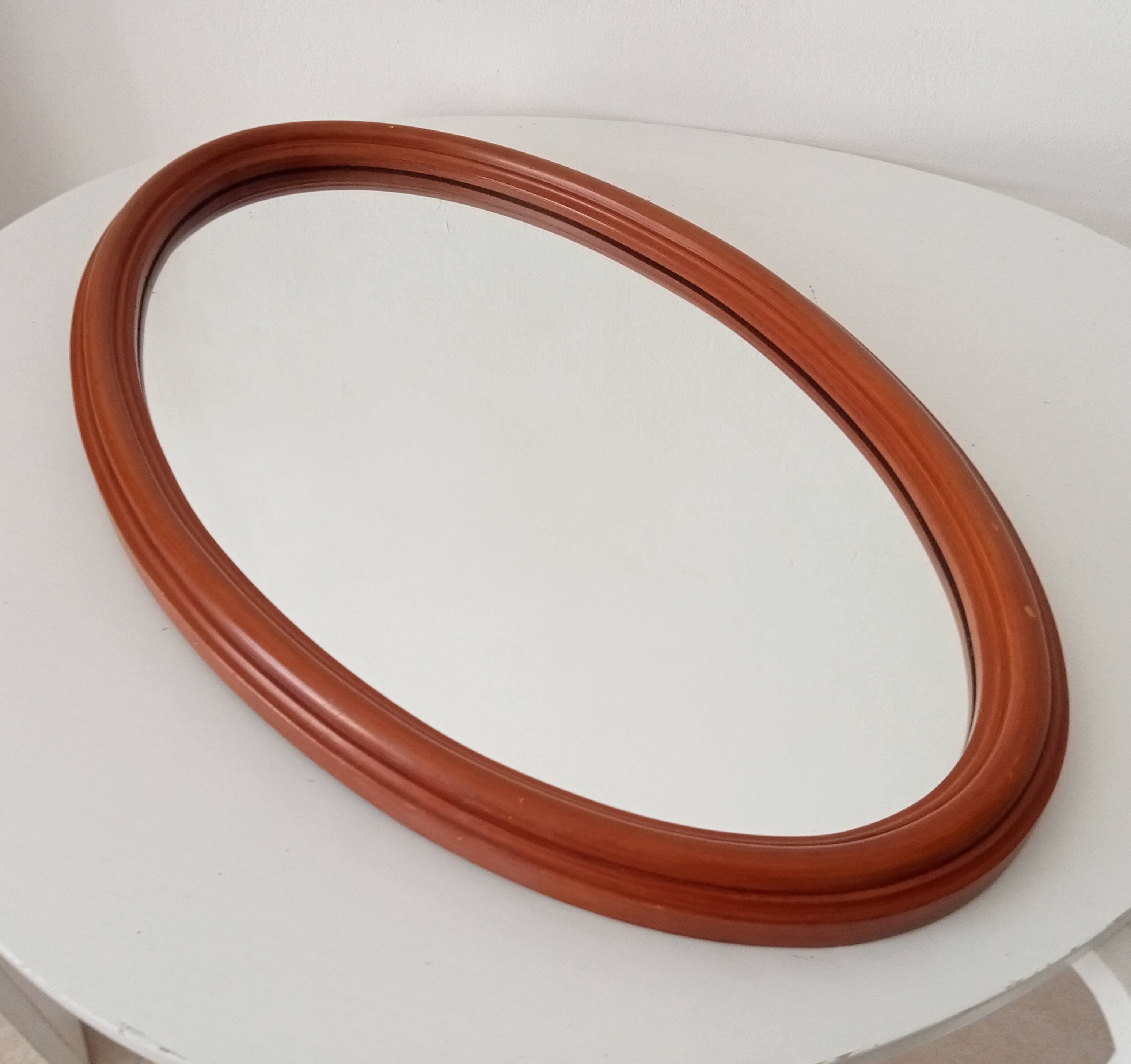 Vintage oval wooden mirror "caramel" from the 1960s.