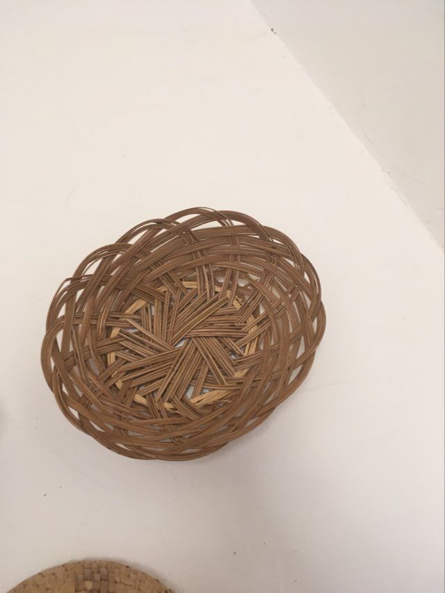 Wall composition of 9 wicker baskets and trays.