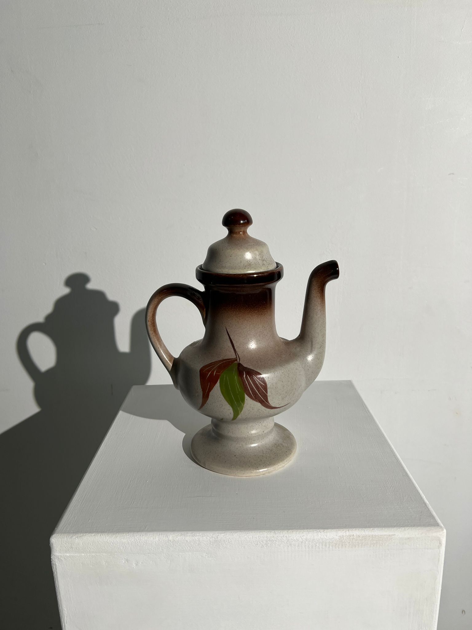 Vintage stoneware teapot with flower and fruit patterns