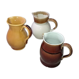 Set of three glazed stoneware pitchers