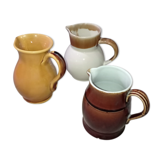 Set of three glazed stoneware pitchers