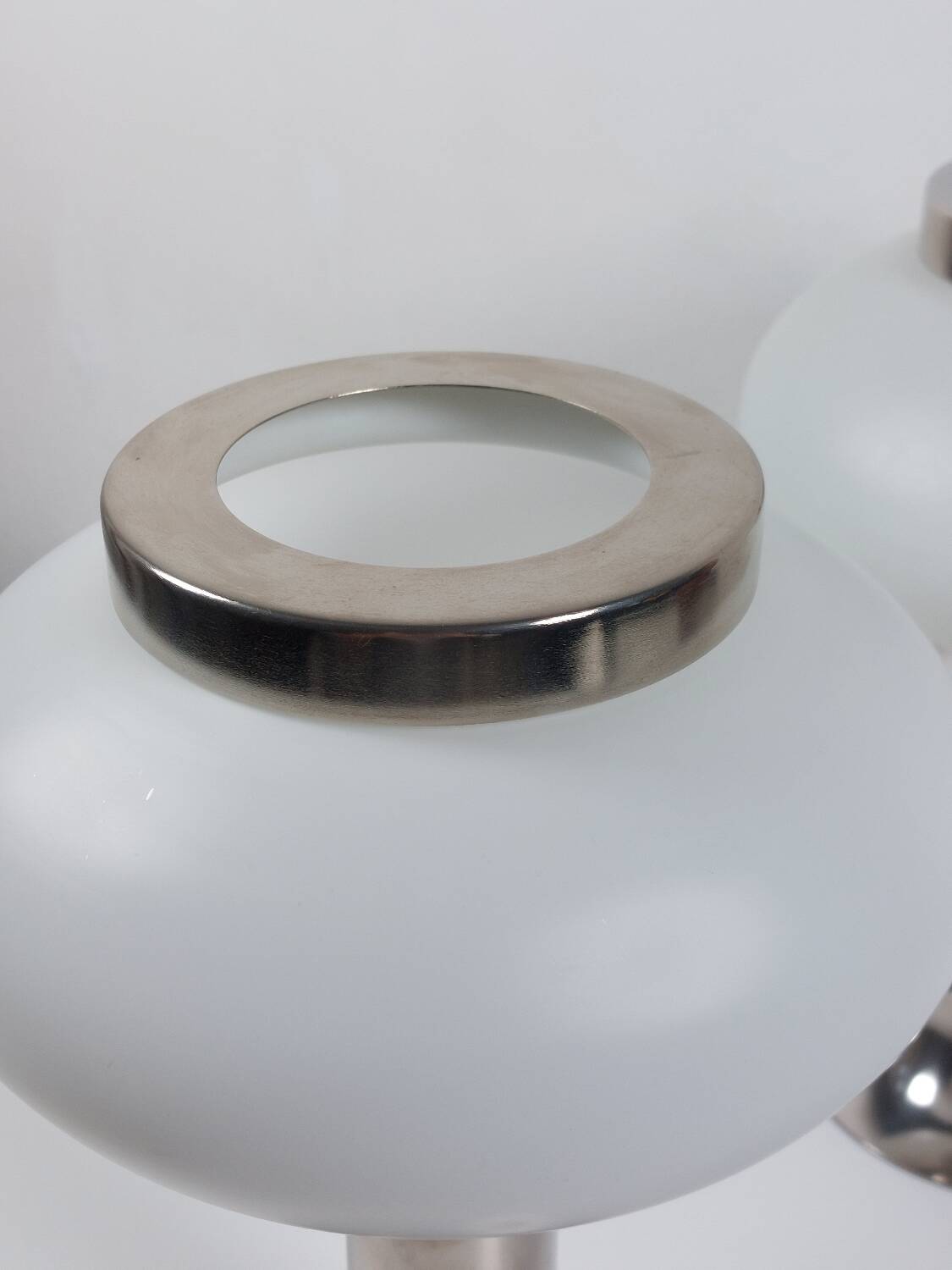 Pair of vintage futuristic style table lamps in chrome and opal glass.