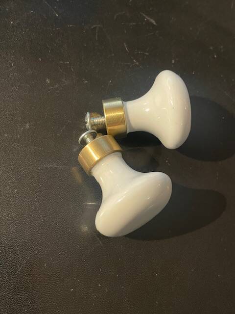 a pair of small antique porcelain and brass knob handles