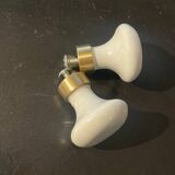a pair of small antique porcelain and brass knob handles