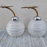 Pair of frosted glass wall lights with brass attachments, circa 1970