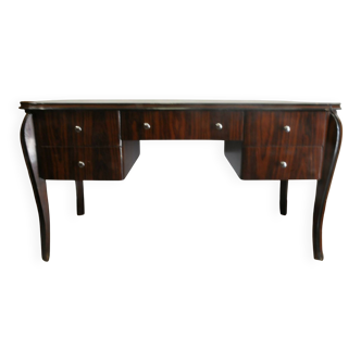 A large Art Deco style rosewood desk with 5 drawers and decorative motifs