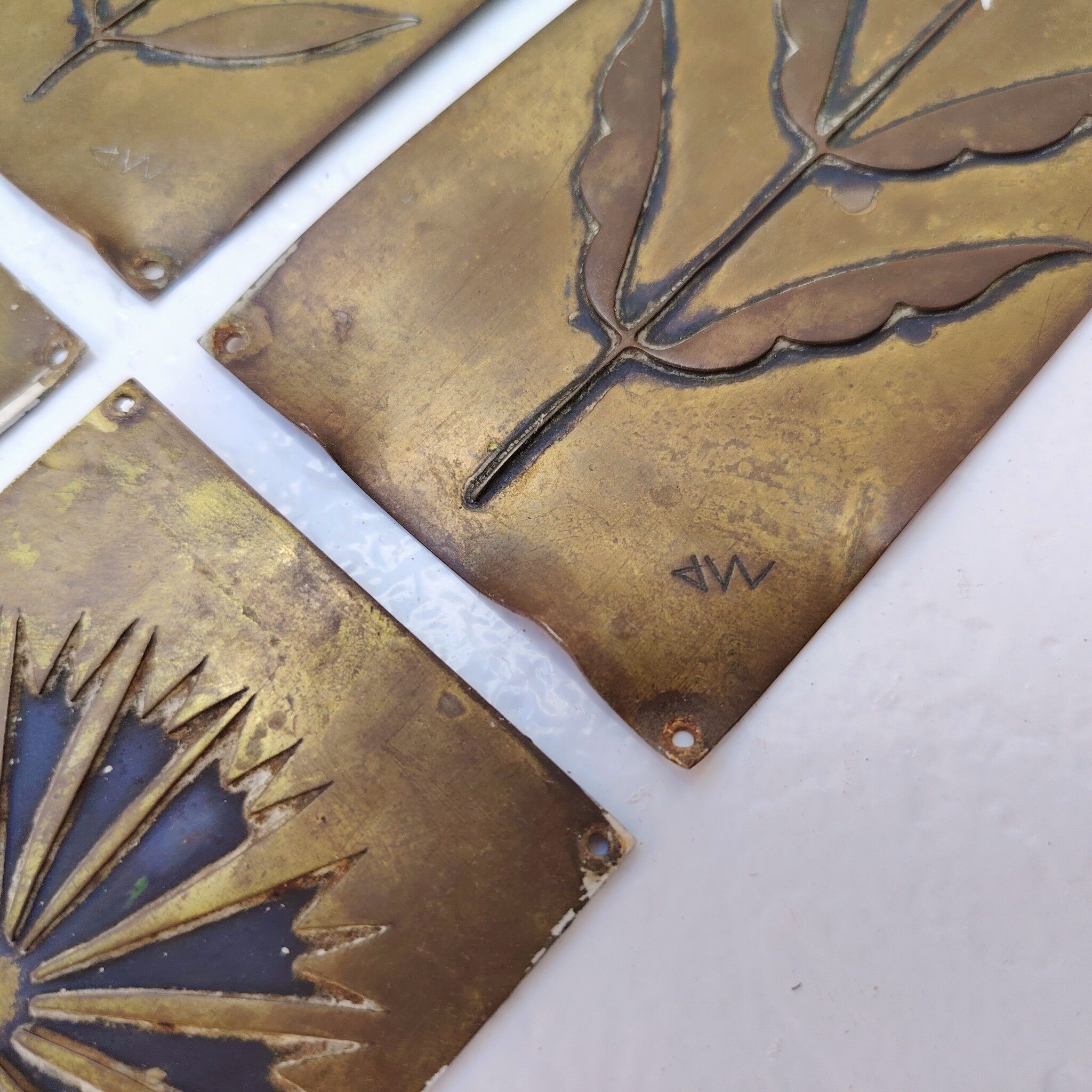 Six cleanliness plaques, flower design, brass.