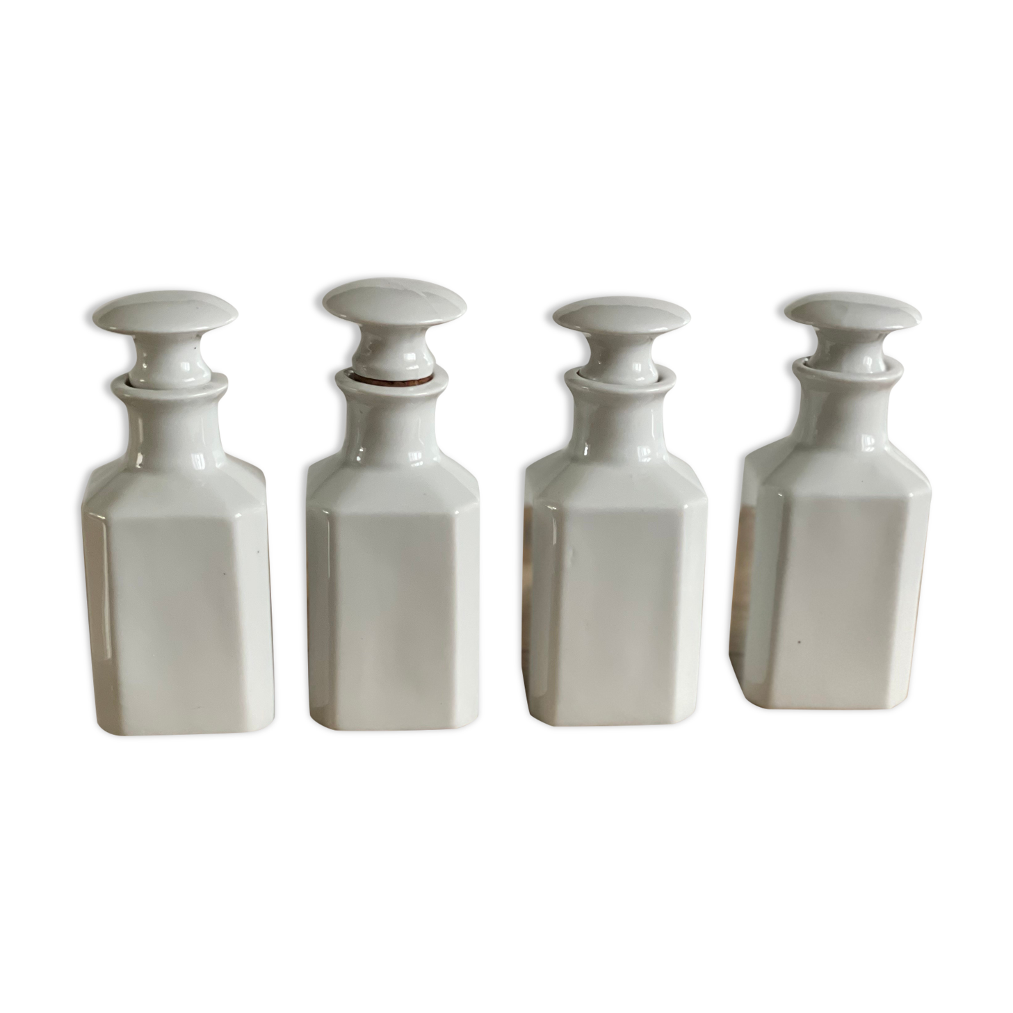 4 old white pharmacy style bottles
