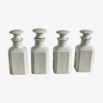 4 old white pharmacy style bottles