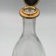Glass bottle type carafe with gold metal bird head stopper