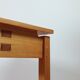 Meticulously crafted vintage pine side table, a masterpiece.