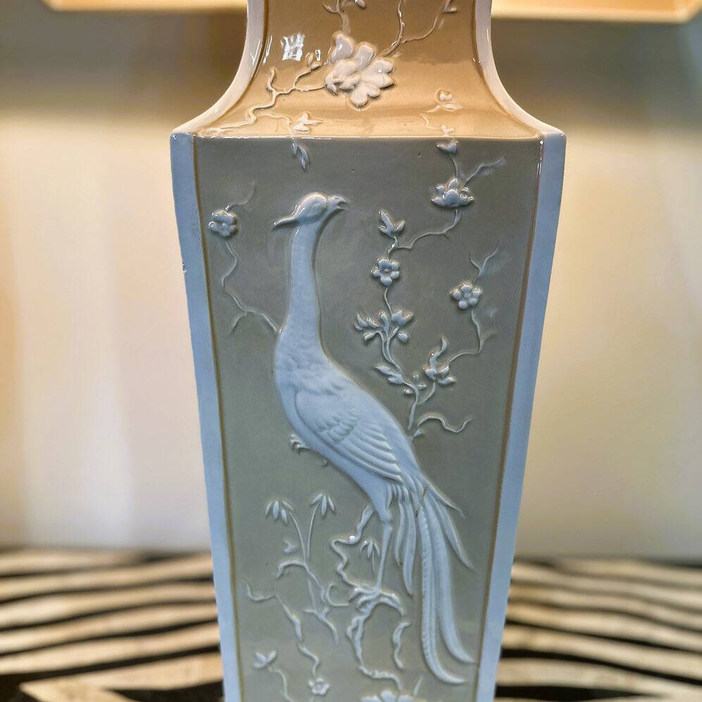 Pair of large cream ceramic table lamps with relief peacocks and fabric shades