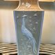Pair of large cream ceramic table lamps with relief peacocks and fabric shades
