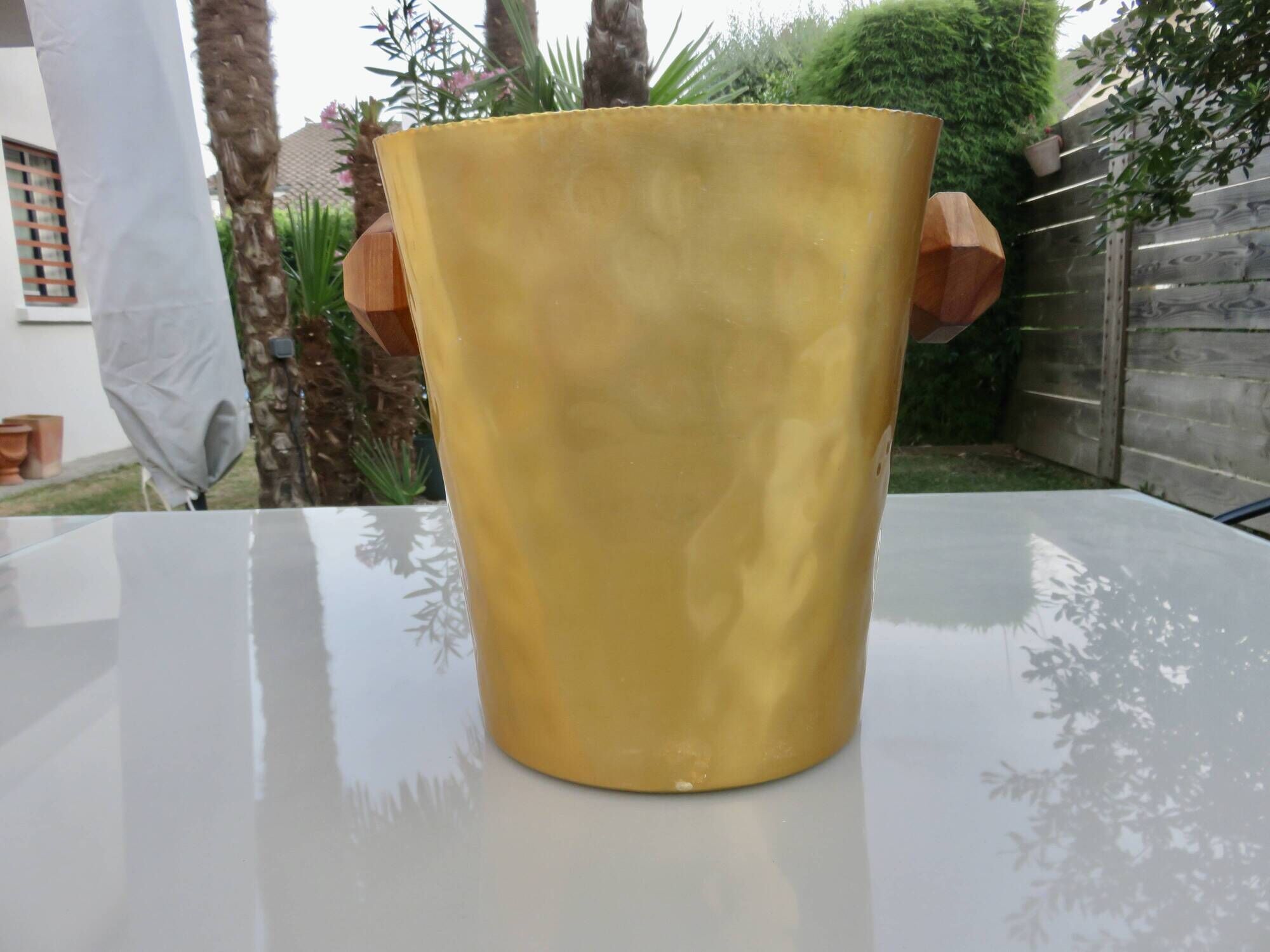 Gold anodised aluminium ice bucket, teak handles, signed T.L PARIS.