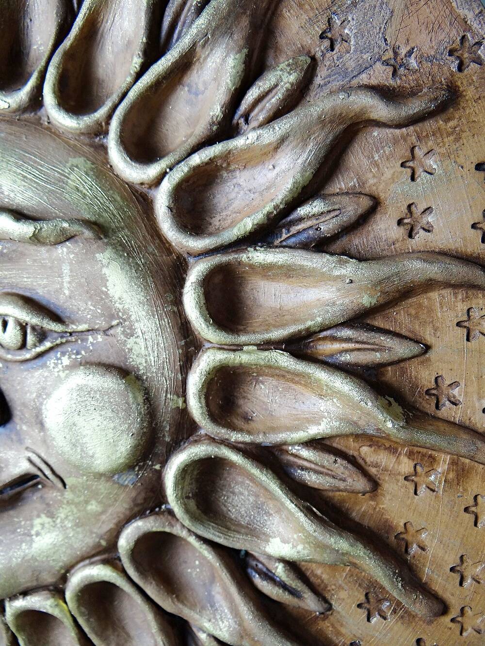 Anthropomorphic sun wall sculpture in patinated terracotta, vintage Italian craftsmanship.