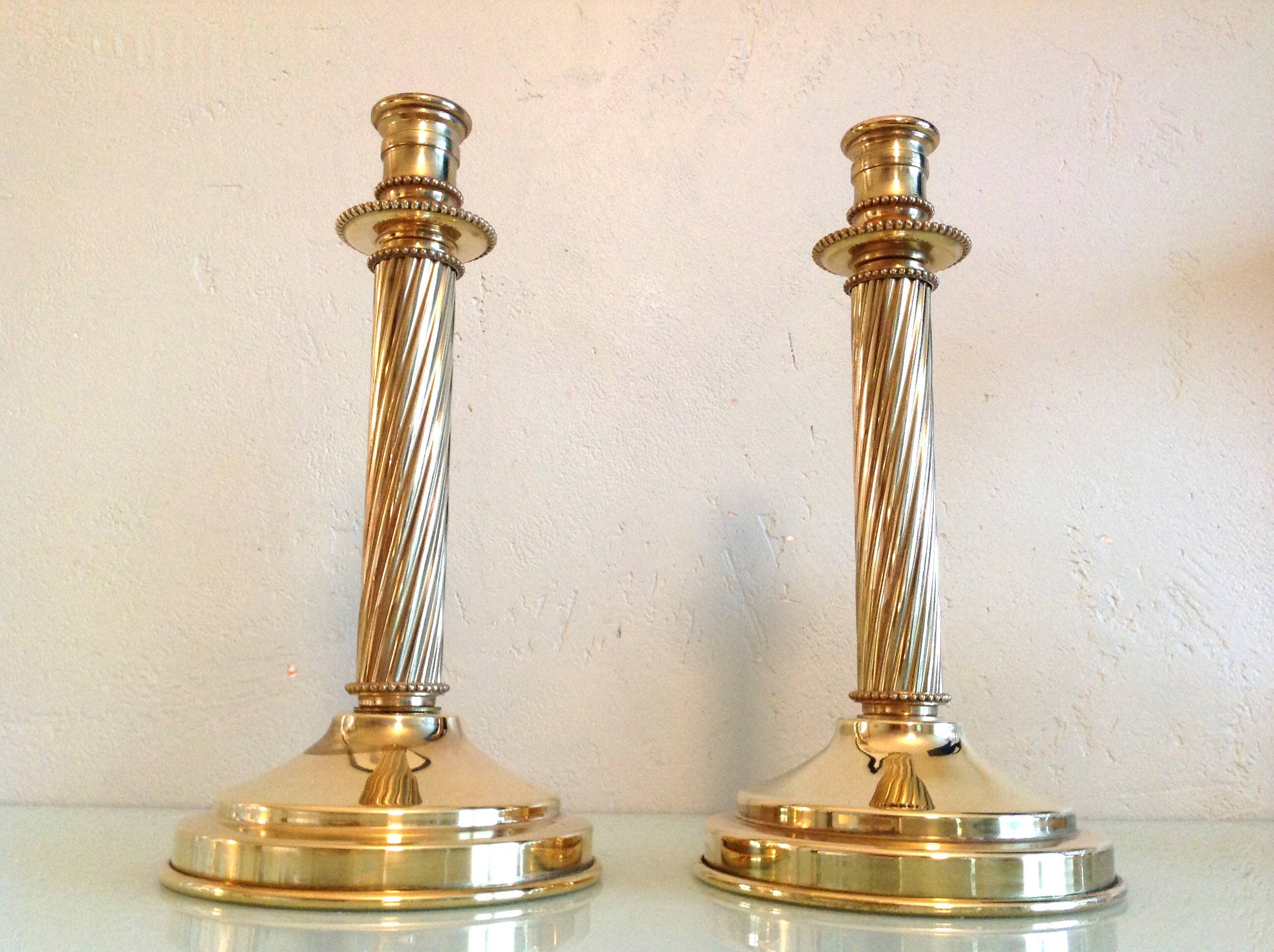 Pair of empire style brass candlesticks
