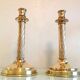Pair of empire style brass candlesticks