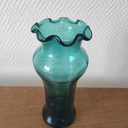 Blown glass vase with a flared neck and wavy rim.