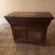 Old solid wood dough mixer carefully transformed into a bar cabinet.