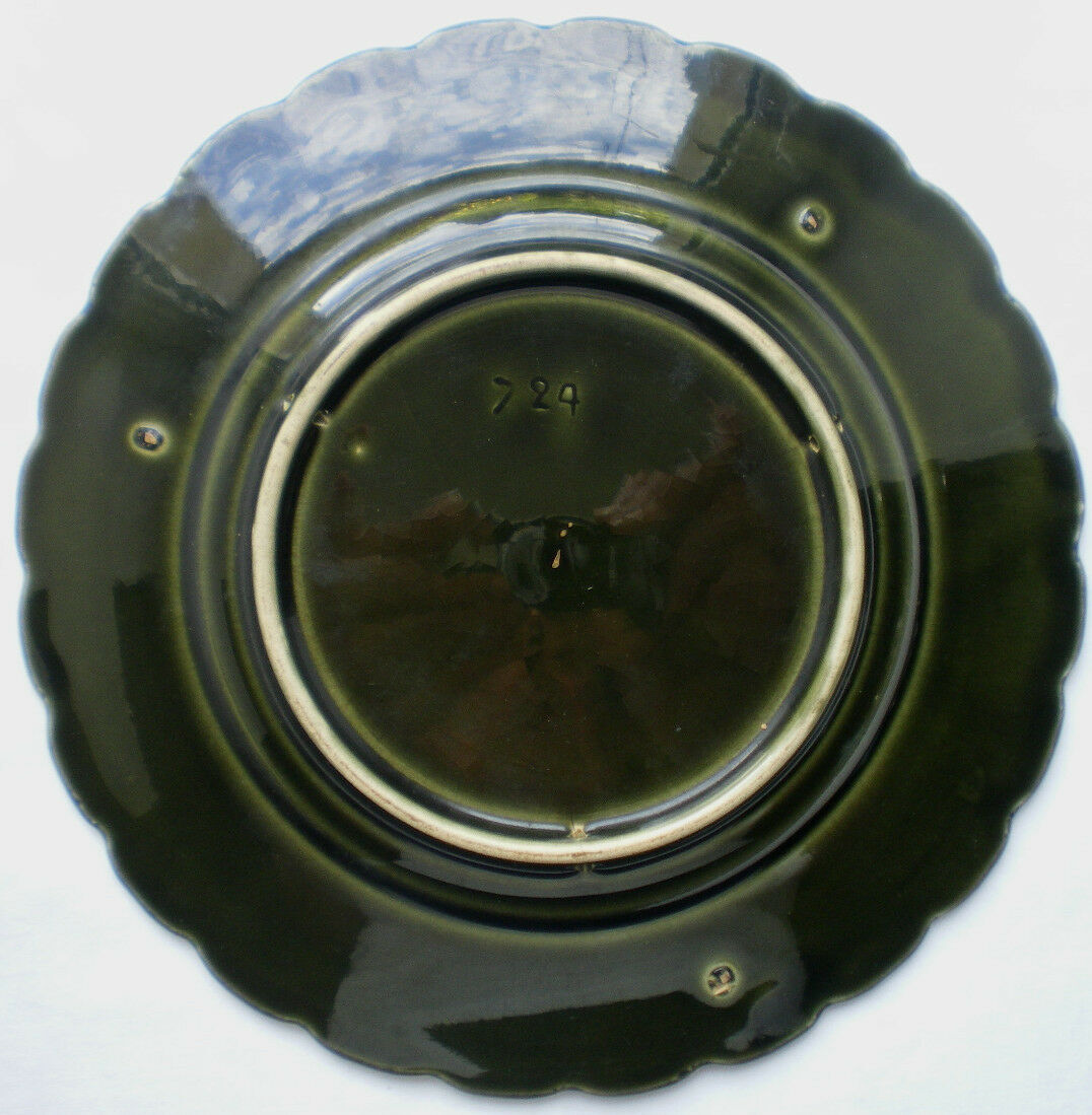 Old plate decorated with anemones or poppies on a black background