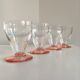 Lot of water in white and pink glass glasses