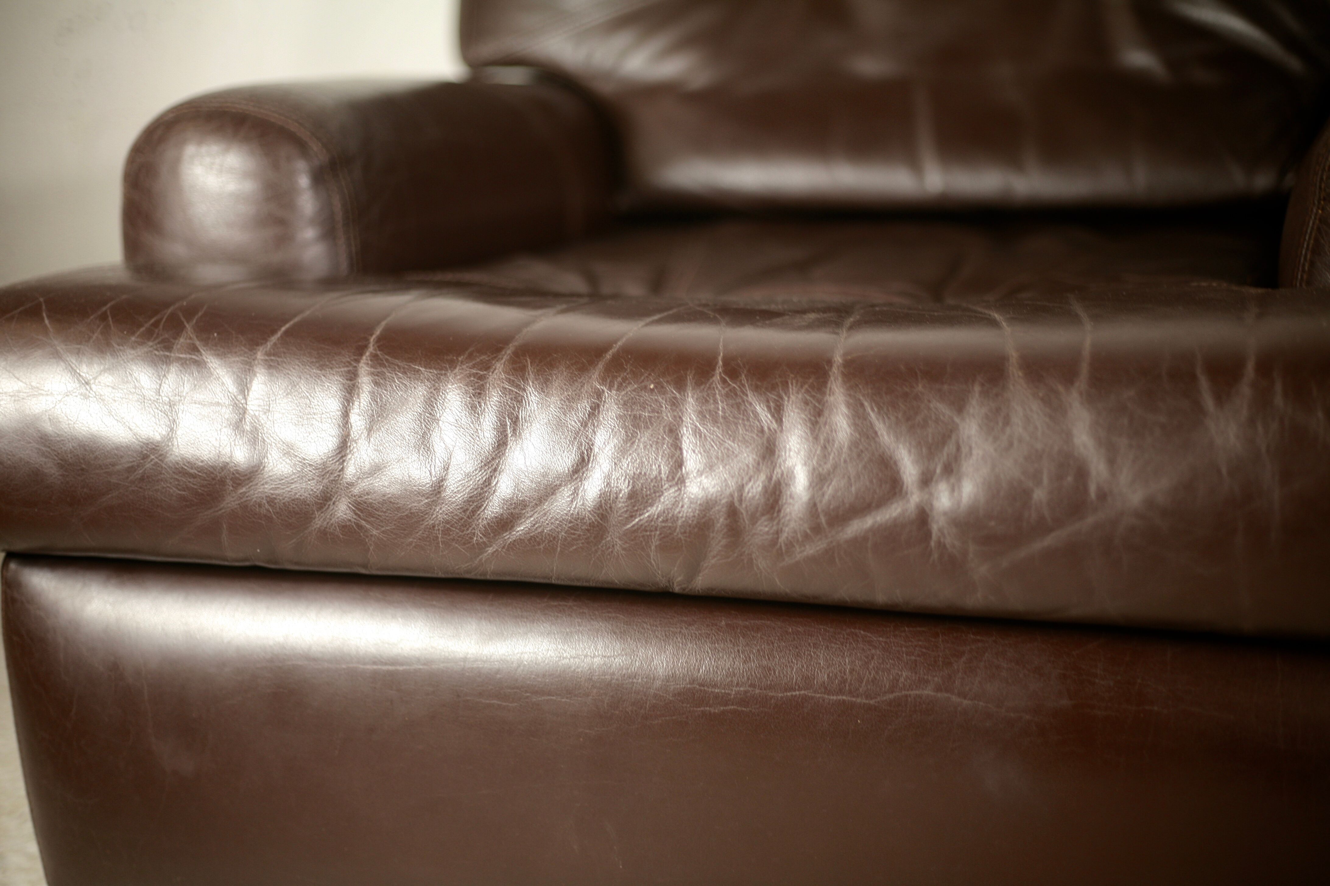 Pair of armchairs brown leather base stainless steel, France, circa 1970