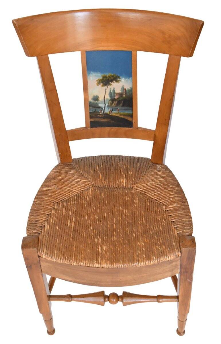 Pair of chairs with slatted backs and painted bands depicting animated landscapes.