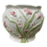 White ceramic pot cache in old flower slip